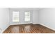 This bedroom features hardwood floors and is illuminated by natural light from large windows at 12612 Majestic Way, Fishers, IN 46037