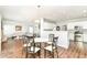 Open dining area with a round table, six chairs, and seamless flow into the living room and kitchen at 12612 Majestic Way, Fishers, IN 46037