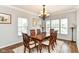 Warm and inviting dining room with wood table and chairs and large windows at 12612 Majestic Way, Fishers, IN 46037