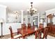 Open-concept dining room featuring a rustic wood table and chairs and hardwood floors at 12612 Majestic Way, Fishers, IN 46037
