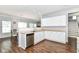 Functional kitchen area with stainless steel dishwasher, white cabinets, and ample countertop space for cooking at 12612 Majestic Way, Fishers, IN 46037