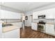 Spacious kitchen with white cabinets, stainless steel appliances, and hardwood floors, offering a modern aesthetic at 12612 Majestic Way, Fishers, IN 46037
