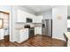 Well-equipped kitchen featuring stainless steel appliances, white cabinetry, and ample counter space for meal preparation at 12612 Majestic Way, Fishers, IN 46037