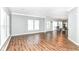 Spacious and open living area with hardwood flooring and large windows for ample natural light and great views at 12612 Majestic Way, Fishers, IN 46037
