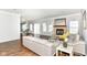 Open-concept living room with stone fireplace, modern decor, hardwood flooring, and great natural light at 12612 Majestic Way, Fishers, IN 46037
