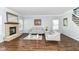 Cozy living room with a stone fireplace, comfortable sofas, and large windows providing natural light at 12612 Majestic Way, Fishers, IN 46037