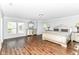 This primary suite features hardwood floors, a large window, and a decorative headboard at 12612 Majestic Way, Fishers, IN 46037