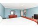 A main bedroom with a wooden bed frame, a dresser, and a view into the closet at 12612 Majestic Way, Fishers, IN 46037