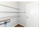 Pantry with wire shelving for organized storage, with hardwood flooring and a white door at 12612 Majestic Way, Fishers, IN 46037