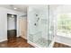 Newly renovated shower includes a glass enclosure and a mosaic tile accent at 12612 Majestic Way, Fishers, IN 46037