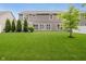 Lush backyard featuring a well-maintained lawn and the rear exterior of the home at 1274 Timber Bluff Rd, Westfield, IN 46074
