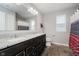 Bathroom features a dual sink vanity, large mirror, tiled floor, and a window at 1274 Timber Bluff Rd, Westfield, IN 46074