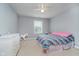Bright bedroom features a ceiling fan, window with blinds, and a colorful striped bedspread at 1274 Timber Bluff Rd, Westfield, IN 46074