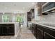 Modern kitchen with stainless steel appliances, granite countertops, and dark wood cabinets at 1274 Timber Bluff Rd, Westfield, IN 46074