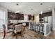 Modern kitchen featuring dark wood cabinetry, granite countertops, stainless steel appliances, and a breakfast bar at 1274 Timber Bluff Rd, Westfield, IN 46074