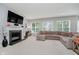 Spacious living room with a fireplace and large sectional sofa with lots of natural light at 1274 Timber Bluff Rd, Westfield, IN 46074