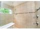 Walk-in shower with a glass door, a built-in bench, multiple shower heads, and neutral-toned tiles at 1274 Timber Bluff Rd, Westfield, IN 46074