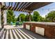 Inviting back deck featuring a pergola, outdoor kitchen, and comfortable seating area at 14805 Chamberlain Dr, Westfield, IN 46074