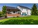 Scenic view of a large backyard with a deck, outdoor seating, and a well-maintained lawn at 14805 Chamberlain Dr, Westfield, IN 46074