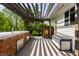 Backyard featuring a wooden pergola, bar area, and outdoor storage at 14805 Chamberlain Dr, Westfield, IN 46074