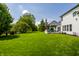 Expansive backyard with lush green lawn and a deck featuring turquoise outdoor seating at 14805 Chamberlain Dr, Westfield, IN 46074