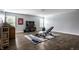 Basement workout room with weight bench, free weights, TV, guitar, and laminate wood flooring at 14805 Chamberlain Dr, Westfield, IN 46074