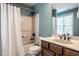 Cozy bathroom includes a tub with shower, toilet, single sink vanity and window with plenty of natural light at 14805 Chamberlain Dr, Westfield, IN 46074