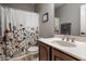 Bathroom featuring a single sink vanity, tiled floors, and floral shower curtain at 14805 Chamberlain Dr, Westfield, IN 46074