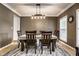 Formal dining room featuring a modern chandelier, large windows, and seating for six at 14805 Chamberlain Dr, Westfield, IN 46074