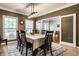 Dining room with a modern chandelier, large windows, and seating for eight at 14805 Chamberlain Dr, Westfield, IN 46074