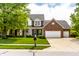 Charming two-story home with a manicured lawn, a three-car garage, and beautiful landscaping at 14805 Chamberlain Dr, Westfield, IN 46074