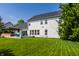 Exterior view of the home with a deck, green lawn, and trees at 14805 Chamberlain Dr, Westfield, IN 46074