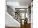 Bright foyer with hardwood floors, staircase and front door view, offering a glimpse of the home's layout at 14805 Chamberlain Dr, Westfield, IN 46074