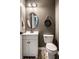 Charming half bathroom featuring a white vanity, decorative mirror, and a chalkboard accent at 14805 Chamberlain Dr, Westfield, IN 46074
