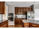 Kitchen with wooden cabinets, stainless steel appliances, granite counters, and center island with marble countertop at 14805 Chamberlain Dr, Westfield, IN 46074