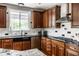 Updated kitchen with dark granite countertops, tile backsplash, and stainless steel appliances at 14805 Chamberlain Dr, Westfield, IN 46074