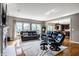Bright living room with large windows, hardwood floors, and a comfortable leather sofa set at 14805 Chamberlain Dr, Westfield, IN 46074