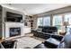 Inviting living room with a fireplace, built-in shelving, hardwood floors and comfortable leather seating at 14805 Chamberlain Dr, Westfield, IN 46074