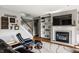 Cozy living room with fireplace, built-in shelving, and a comfortable leather recliner at 14805 Chamberlain Dr, Westfield, IN 46074