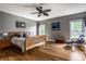Bright and airy main bedroom with hardwood floors, a ceiling fan, and ample natural light at 14805 Chamberlain Dr, Westfield, IN 46074