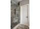 Tiled shower with glass door features a built-in bench, recessed shelving, and rainfall shower head at 14805 Chamberlain Dr, Westfield, IN 46074