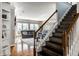 Stylish staircase connecting to the living room, featuring wood steps and natural light at 14805 Chamberlain Dr, Westfield, IN 46074
