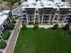 Aerial view of multi-story apartment building with brick accents and balconies overlooking a well-manicured lawn at 15 W Executive Dr # 101, Carmel, IN 46032