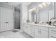 Elegant bathroom with double vanity, marble floors, and a glass-enclosed shower at 15 W Executive Dr # 101, Carmel, IN 46032