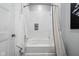 Bright bathroom featuring a bathtub with shower, subway tile, and recessed niche for storage at 15 W Executive Dr # 101, Carmel, IN 46032