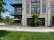Stylish condominium with brick facade, glass balconies, and manicured landscaping at 15 W Executive Dr # 101, Carmel, IN 46032