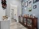 Hallway features hardwood floors, a stylish console, and wall art, leading to the bathroom at 15 W Executive Dr # 101, Carmel, IN 46032