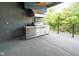 Covered outdoor kitchen features a high end stainless steel grill on a concrete patio at 15 W Executive Dr # 101, Carmel, IN 46032