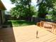 Backyard featuring a spacious deck and a well-maintained lawn, enclosed by a wooden fence at 1612 Prairieview Ln, Greenfield, IN 46140