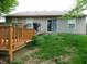 The backyard has a wooden deck, sliding glass door, green grass, and a grill at 1612 Prairieview Ln, Greenfield, IN 46140